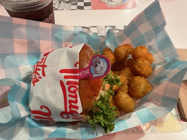 Danny holding a burger from Monty's Good Burger